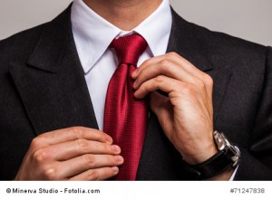 Businessman adjusting his necktie